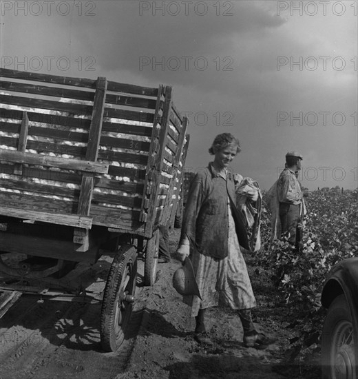 Migratory cotton pickers have stopped working because it started to rain, Kern County, CA, 1938. Creator: Dorothea Lange.