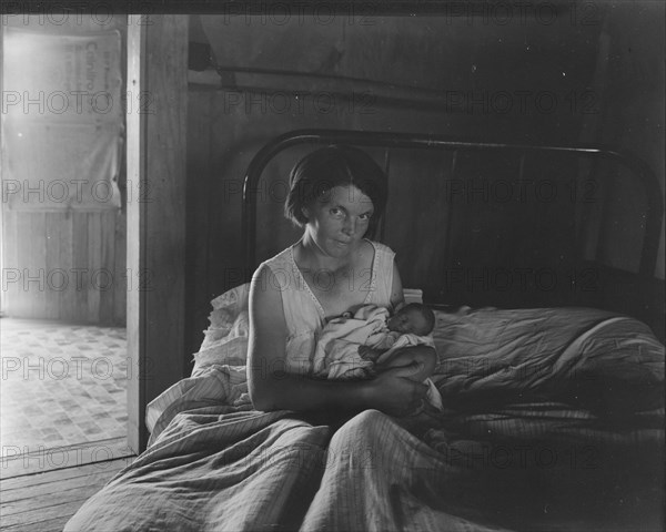 Sharecropper's wife and her youngest child, near Cleveland, Mississippi, 1937. Creator: Dorothea Lange.