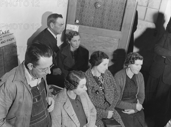 Night meeting in the FSA office, Visalia, Tulare County, California, 1938. Creator: Dorothea Lange.