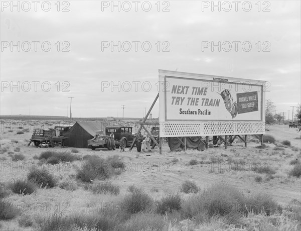 Billboard along U.S. 99...three destitute families...Kern County, CA, 1938. Creator: Dorothea Lange.