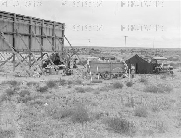 Billboard along U.S. 99...three destitute families...Kern County, CA, 1938. Creator: Dorothea Lange.