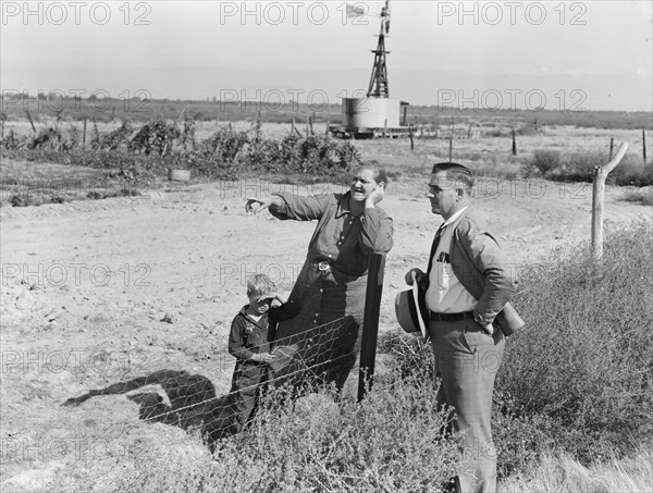 Rural rehabilitation client talking with county supervisor, FSA, Tulare County, California, 1938. Creator: Dorothea Lange.