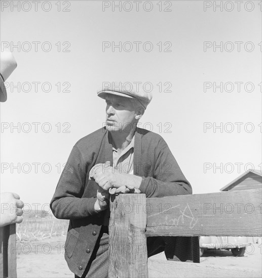 Rehabilitation client talking over fence with county supervisor, near Stockton, CA, 1938. Creator: Dorothea Lange.