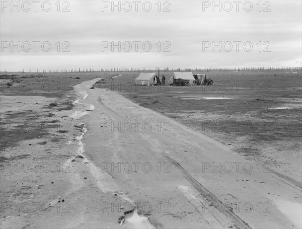 Camp of two related families seen from U.S. 99., Kern County, California, 1939. Creator: Dorothea Lange.