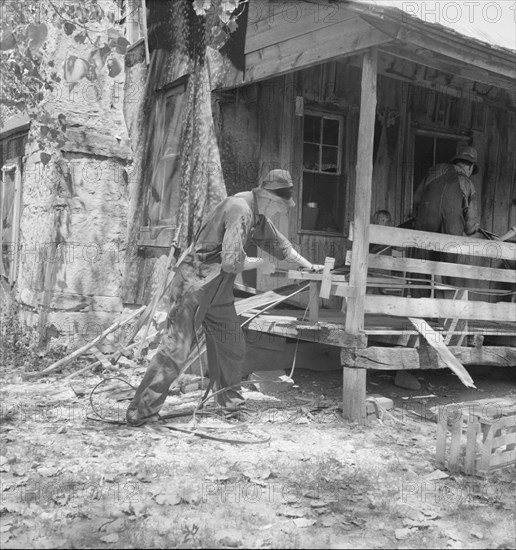 In Arkansas Hills (Ozarks) near Seligman, Missouri, splitting hickory for chair-bottoms, 1938. Creator: Dorothea Lange.