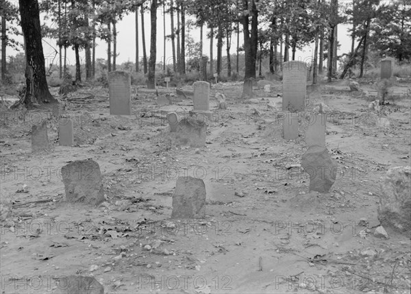 A red clay Negro cemetery, Bethel Hill High School, Person County, North Carolina, 1939. Creator: Dorothea Lange.