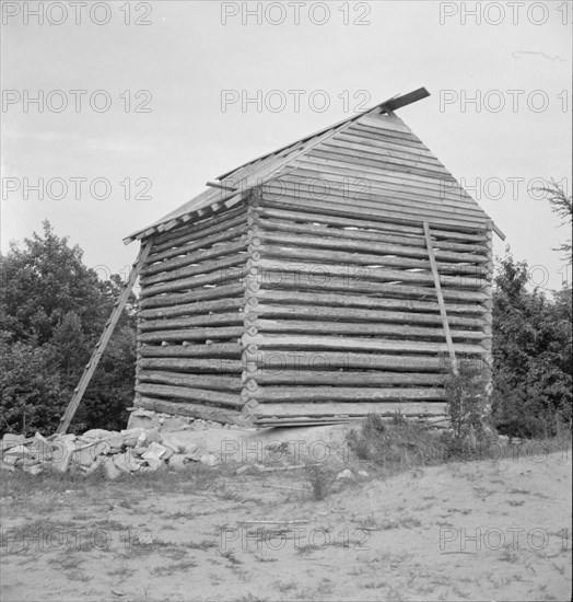 Log cabin barn under construction, near Concord, Person County, North Carolina, 1939. Creator: Dorothea Lange.