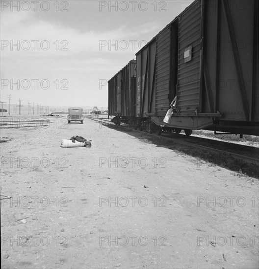 Car on siding across tracks from pea packing plant, Calipatria, Imperial Valley, 1939. Creator: Dorothea Lange.