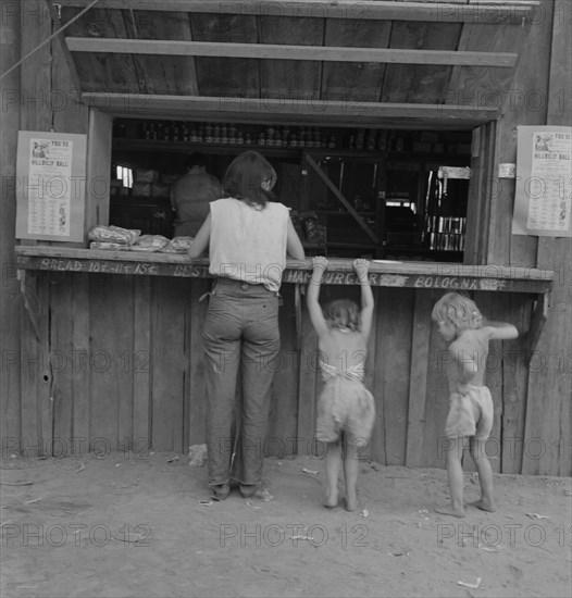 Hop picker with her children goes from..., near Grants Pass, Josephine County, Oregon, 1939. Creator: Dorothea Lange.