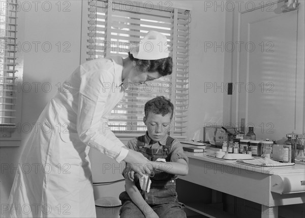 Migratory boys come to the clinic for attention, FSA camp at Farmersville, Tulare County, 1939. Creator: Dorothea Lange.