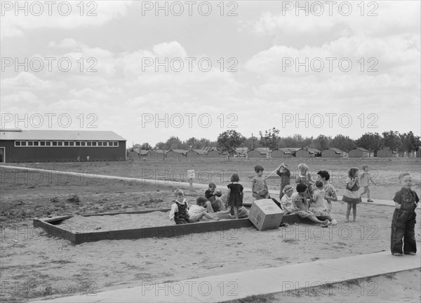 Nursery school children with their teacher, FSA camp, Tulare County, California, 1939. Creator: Dorothea Lange.