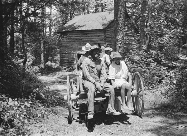 Possibly: Colored sharecropper and his children about to leave..., Shoofly, North Carolina, 1939. Creator: Dorothea Lange.