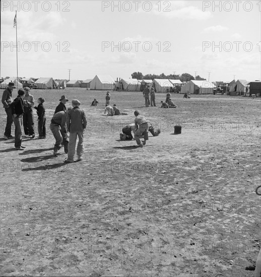 Marble time in FSA migratory labor camp, near Calipatria, Imperial Valley, CA, 1939. Creator: Dorothea Lange.