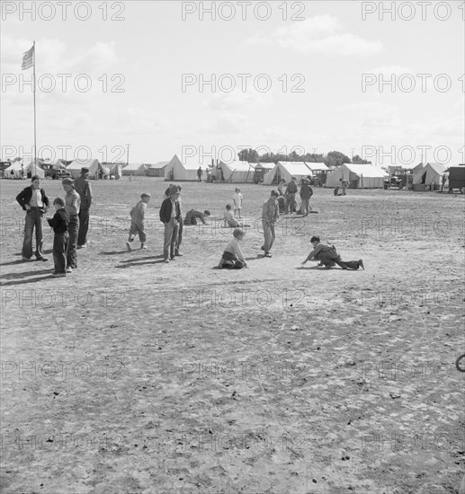 Marble time in FSA migratory labor camp, near Calipatria, Imperial Valley, CA, 1939. Creator: Dorothea Lange.