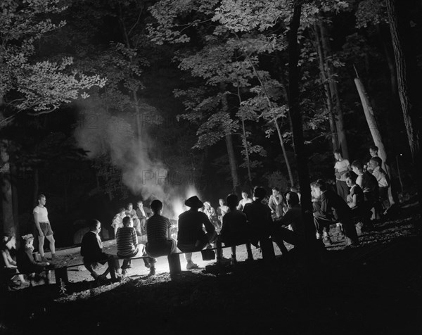 Singing around the camp fire at Camp Nathan Hale, Southfields, New York, 1943 Creator: Gordon Parks.