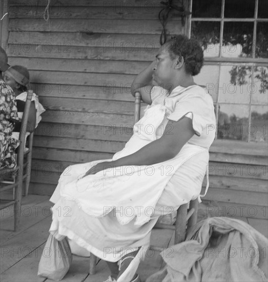 Possibly: Mother of sharecropper family and friend...the rain, Person County, North Carolina, 1939. Creator: Dorothea Lange.