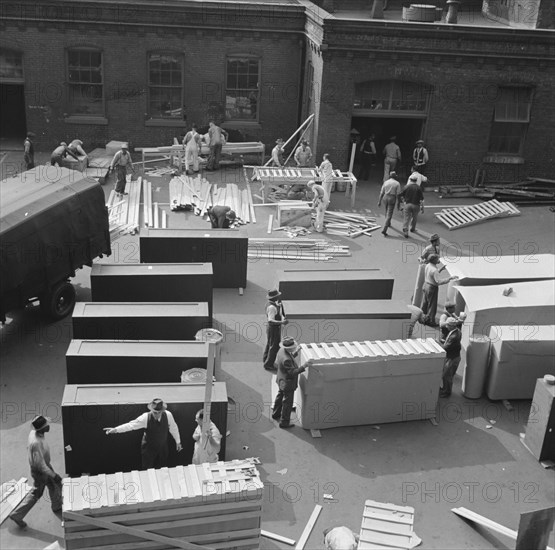 United States government workers and carpenters making crates for steel... Washington, D.C., 1942. Creator: Gordon Parks.