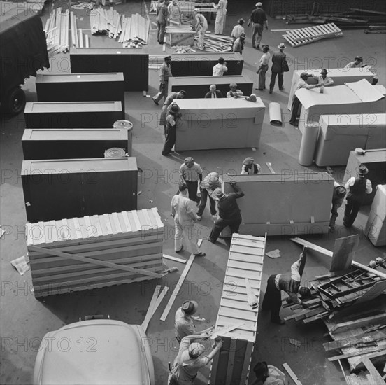 United States government workers and carpenters making crates for steel..., Washington, D.C., 1942. Creator: Gordon Parks.