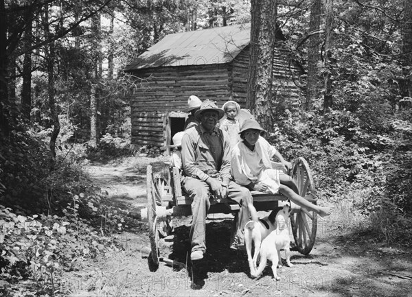 Colored sharecropper and his children about to leave..., Shoofly, North Carolina, 1939. Creator: Dorothea Lange.