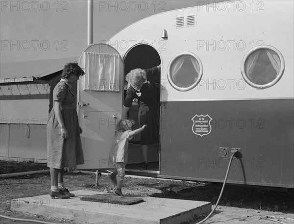 Young mother brings her child to the trailer clinic..., FSA, Merrill, Klamath County, Oregon, 1939. Creator: Dorothea Lange.