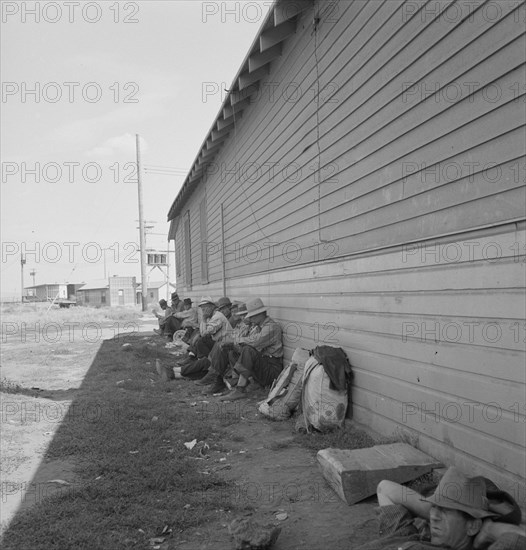 Possibly: Idle men seated in shade on the other side..., Tulelake, Siskiyou County, California, 1939 Creator: Dorothea Lange.