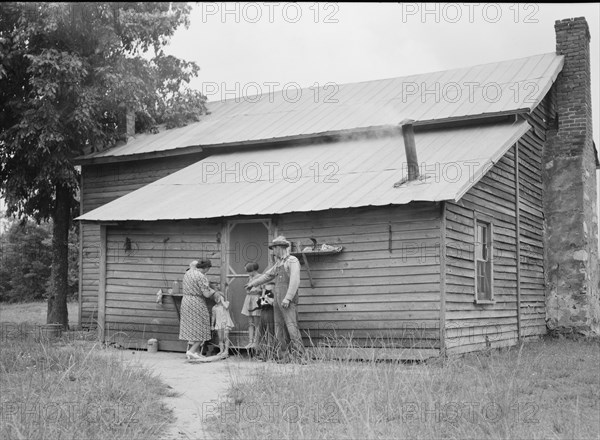 Tobacco sharecropper and his family at the back..., Person County, North Carolina, 1939. Creator: Dorothea Lange.