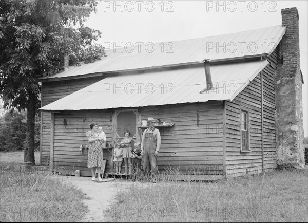 Tobacco sharecropper and his family at the back..., Person County, North Carolina, 1939. Creator: Dorothea Lange.