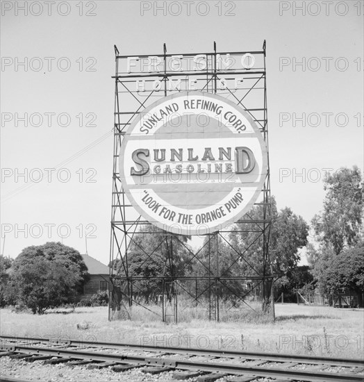 Illuminated sign, approaching San Joaquin Valley town, outskirts of Fresno, on U.S. 99, CA, 1939. Creator: Dorothea Lange.