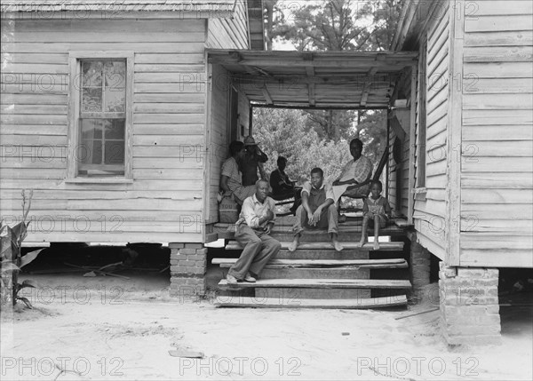 Zollie Lyons, Negro sharecropper, home from the field for dinner..., Upchurch, North Carolina, 1939. Creator: Dorothea Lange.