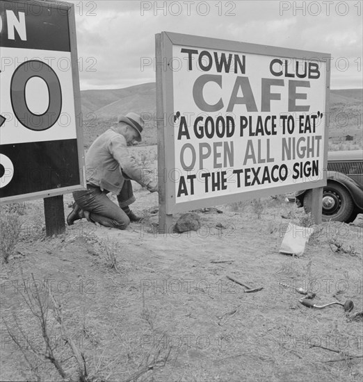 New sign along highway advertises a new enterprise in the lonely town of Maupin, Oregon, 1939. Creator: Dorothea Lange.