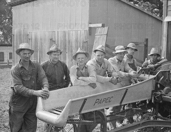 Seven of the eight farmers shown with their coop...West Carlton, Yamhill County, Oregon, 1939. Creator: Dorothea Lange.