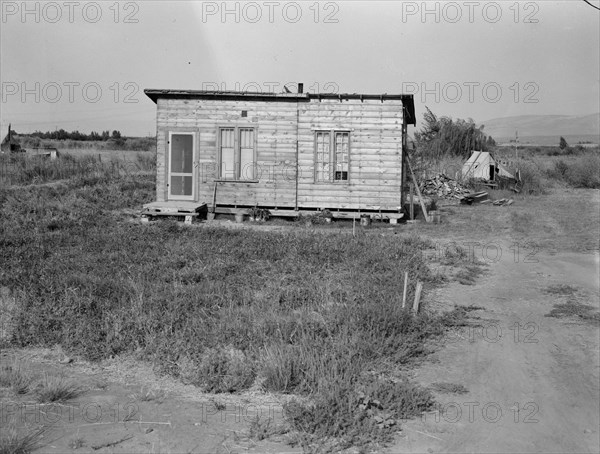 Homes are built bit by bit with whatever materials are available, Yakima,Washington, 1939. Creator: Dorothea Lange.