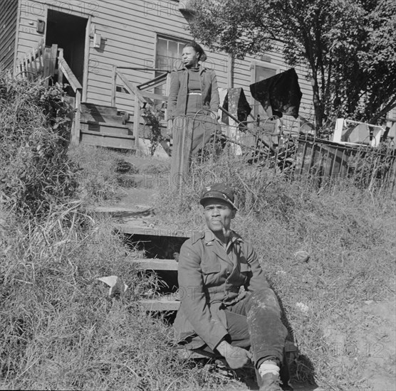 Mr. and Mrs. Venus Alsobrook in front of their home in the southwest section, Washington, DC, 1942. Creator: Gordon Parks.