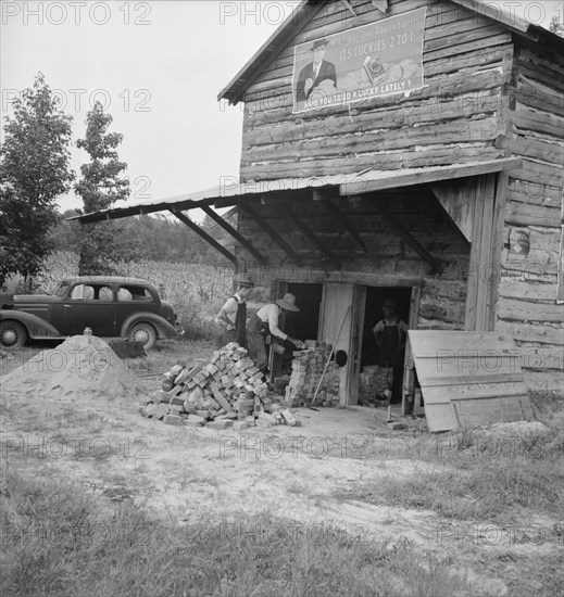 Putting in new flues in tobacco barn, Orange County, North Carolina, 1939. Creator: Dorothea Lange.