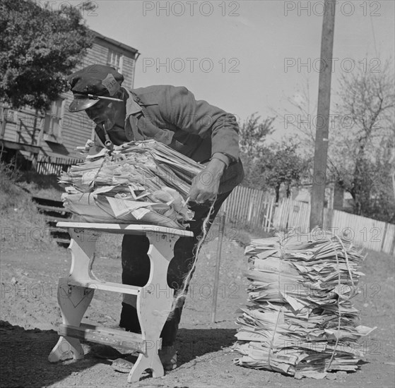 Mr. Venus Alsobrook, official salvage collector for the government wrapping..., Washington, DC, 1942 Creator: Gordon Parks.