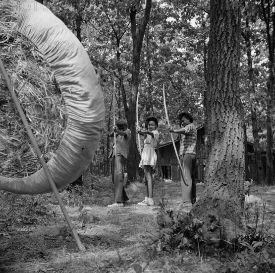 Practicing on the archery range at Camp Fern Rock, Bear Mountain, New York, 1943 Creator: Gordon Parks.