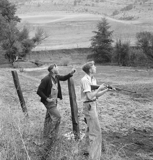 Farmer and boy in the fall of the year at the time the hunting..., Jackson County, Oregon, 1939. Creator: Dorothea Lange.