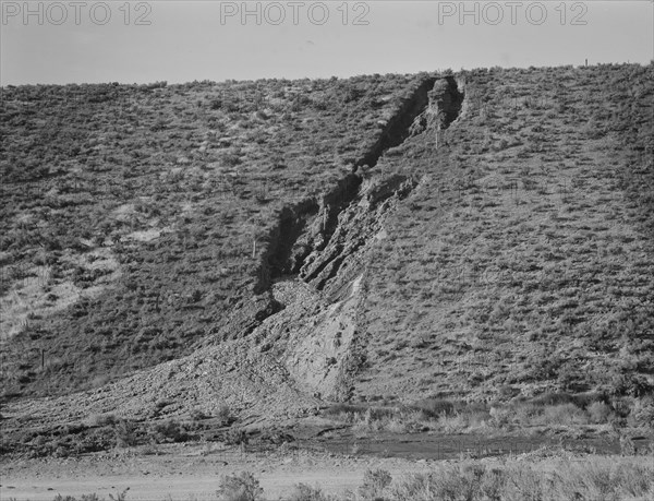 Water seepage from newly irrigated land on top of bench, eroding sides, Dead Ox Flat, Oregon, 1939. Creator: Dorothea Lange.