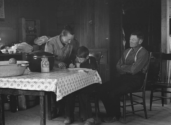 The Wardlow family in their dugout basement home on Sunday, Dead Ox Flat, Oregon, 1939. Creator: Dorothea Lange.