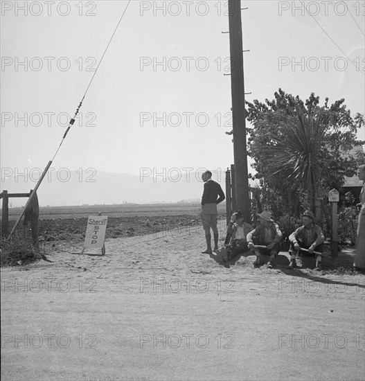 Deputized "vigilantes" armed with clubs guard entrance..., Salinas Valley, California, 1939. Creator: Dorothea Lange.