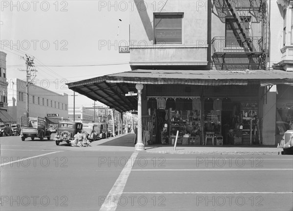 Street corner of San Joaquin Valley town on U.S. 99 showing secondhand store, Fresno, CA, 1939. Creator: Dorothea Lange.