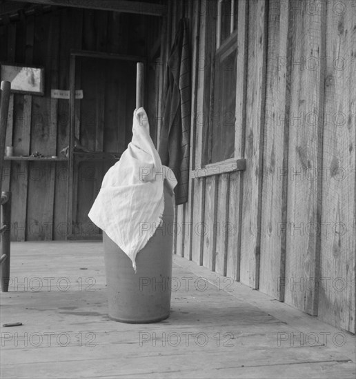 Pottery butter churn on porch of Negro tenant..., Randolph County, North Carolina, 1939. Creator: Dorothea Lange.