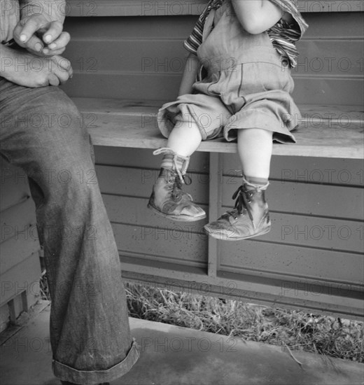 Baby with club feet wearing homemade splints, FSA camp, Tulare County, California, 1939. Creator: Dorothea Lange.