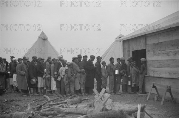 Possibly: Negroes in the lineup for food at meal time in the camp..., Forrest City, Arkansas, 1937. Creator: Walker Evans.