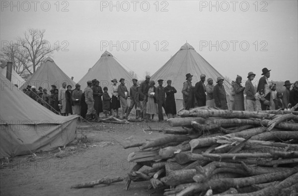 Possibly: Negroes in the lineup for food at meal time in the camp..., Forrest City, Arkansas, 1937. Creator: Walker Evans.