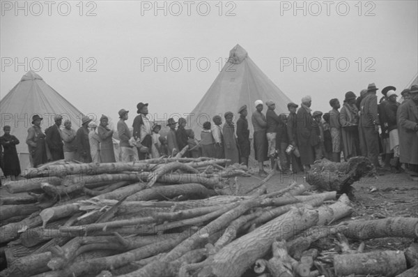 Possibly: Negroes in the lineup for food at meal time in the camp..., Forrest City, Arkansas, 1937. Creator: Walker Evans.