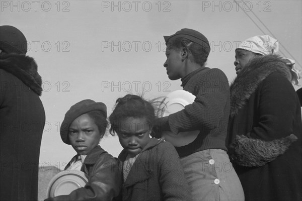 Possibly: Negroes in the lineup for food at meal time at the camp..., Forrest City, Arkansas, 1937. Creator: Walker Evans.