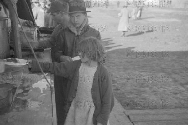 Possibly: Negroes in the lineup for food at mealtime in the camp..., Forrest City, Arkansas, 1937. Creator: Walker Evans.