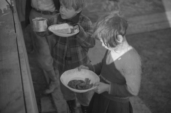 Possibly: Negroes in the lineup for food at mealtime in the camp..., Forrest City, Arkansas, 1937. Creator: Walker Evans.