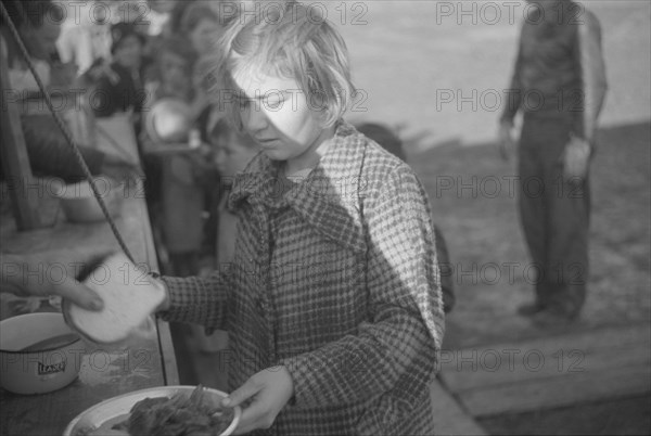 Possibly: Negroes in the lineup for food at mealtime in the camp..., Forrest City, Arkansas, 1937. Creator: Walker Evans.